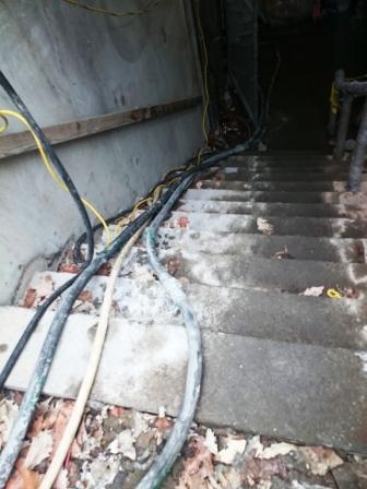 Two pumping hoses going down to the subway